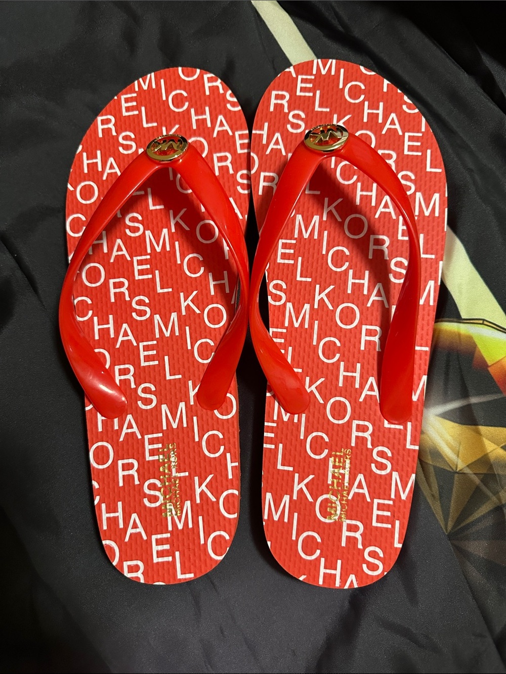 Michael Kors Red Logo Pattern Flip Flops with Gold Emblems